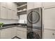 Modern laundry room with sleek, stacked washer and dryer at 15 Vintage Canyon St, Las Vegas, NV 89141
