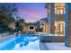 Resort-style pool area with a built-in hot tub, ample seating, and lush landscaping at 15 Vintage Canyon St, Las Vegas, NV 89141
