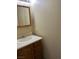 Bathroom with a wooden vanity with a sink and mirror at 158 Greenbriar Townhouse Way, Las Vegas, NV 89121