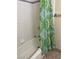 Bathroom with a standard white tub and tiled walls at 158 Greenbriar Townhouse Way, Las Vegas, NV 89121