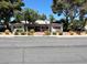 Charming building exterior with red trim and well-maintained landscaping at 158 Greenbriar Townhouse Way, Las Vegas, NV 89121