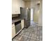 Kitchen features stainless steel appliances, granite counters, and tile flooring at 158 Greenbriar Townhouse Way, Las Vegas, NV 89121