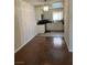 Bright eat-in kitchen with chandelier, tile floor, and white cabinets at 158 Greenbriar Townhouse Way, Las Vegas, NV 89121