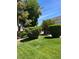Beautifully landscaped green space with mature trees and well-maintained bushes at 158 Greenbriar Townhouse Way, Las Vegas, NV 89121
