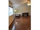 Bright living room featuring hardwood floors, ceiling fan, and large windows at 158 Greenbriar Townhouse Way, Las Vegas, NV 89121