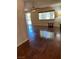 Living room featuring wood floors, ceiling fan and large window at 158 Greenbriar Townhouse Way, Las Vegas, NV 89121