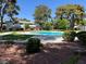 Community pool with mature trees and manicured lawns creating a relaxing atmosphere at 158 Greenbriar Townhouse Way, Las Vegas, NV 89121
