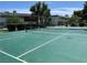 Well-maintained tennis court with green surface, net and fencing at 158 Greenbriar Townhouse Way, Las Vegas, NV 89121