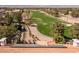 Aerial view highlights the golf course backing this home's solar panels and landscaping at 1613 Iron Ridge Dr, Las Vegas, NV 89117