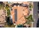 Aerial view features the home's solar panels, pergola patio, pool and lush landscaping at 1613 Iron Ridge Dr, Las Vegas, NV 89117