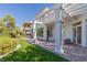 Well-maintained backyard with lush artificial turf, a brick patio, and a pergola, perfect for outdoor living at 1613 Iron Ridge Dr, Las Vegas, NV 89117