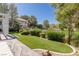 Inviting backyard featuring lush artificial turf, landscaping, and a tranquil view of the golf course at 1613 Iron Ridge Dr, Las Vegas, NV 89117