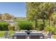 Tranquil backyard view with dining area overlooking lush greenery and golf course in the distance at 1613 Iron Ridge Dr, Las Vegas, NV 89117
