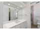 Bright bathroom featuring a large mirror, white vanity, and a separate shower and toilet area at 1613 Iron Ridge Dr, Las Vegas, NV 89117