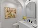 Bright bathroom featuring a modern vanity, sleek fixtures, and stylish floral art at 1613 Iron Ridge Dr, Las Vegas, NV 89117