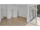 Spacious, light-filled bedroom featuring modern wood flooring, neutral walls, and access to a private balcony at 1613 Iron Ridge Dr, Las Vegas, NV 89117