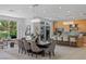 Bright dining room with modern light fixture and golf course view at 1613 Iron Ridge Dr, Las Vegas, NV 89117