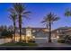 Elegant two-story home with well-manicured landscaping, a tile roof and a three-car garage at 1613 Iron Ridge Dr, Las Vegas, NV 89117