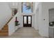 Bright foyer with staircase, chandelier and double front doors at 1613 Iron Ridge Dr, Las Vegas, NV 89117