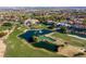 Aerial view of the golf course showcasing lush green fairways, scenic water hazards, and beautiful homes in a serene setting at 1613 Iron Ridge Dr, Las Vegas, NV 89117