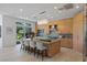 Modern kitchen with a large island, counter seating, stainless appliances, and sliding doors to backyard at 1613 Iron Ridge Dr, Las Vegas, NV 89117