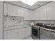 Modern laundry room with sleek cabinetry, countertops, stainless steel washer and dryer units at 1613 Iron Ridge Dr, Las Vegas, NV 89117