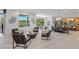 Open-concept living area boasts neutral color palette, tile floors and views of the outdoor golf course at 1613 Iron Ridge Dr, Las Vegas, NV 89117