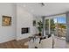 Bright living room features a stone fireplace and a sliding glass door to a patio at 1613 Iron Ridge Dr, Las Vegas, NV 89117