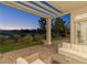 Covered patio with comfortable seating overlooks manicured lawn and golf course views at 1613 Iron Ridge Dr, Las Vegas, NV 89117