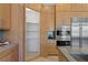 Well-organized pantry with ample shelving and an adjacent stainless steel refrigerator and wall ovens at 1613 Iron Ridge Dr, Las Vegas, NV 89117