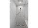 An elegant shower featuring white marble-style tiling with a rainfall shower head and modern fixtures at 1613 Iron Ridge Dr, Las Vegas, NV 89117