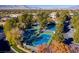 Aerial view of community tennis courts surrounded by mature trees providing shade and privacy for an active lifestyle at 1613 Iron Ridge Dr, Las Vegas, NV 89117