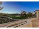 Scenic view of the golf course and mountains from the balcony of the residence at 1613 Iron Ridge Dr, Las Vegas, NV 89117