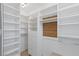 Spacious walk-in closet with custom shelving and drawers at 1613 Iron Ridge Dr, Las Vegas, NV 89117