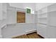 A walk-in closet with custom shelving, drawers, and a seating area offer ample storage at 1613 Iron Ridge Dr, Las Vegas, NV 89117