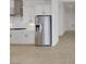 Modern kitchen with stainless steel refrigerator, white cabinets and marble countertops at 164 Cabo Cruces Dr, Henderson, NV 89011