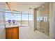 Modern bathroom features a glass enclosed shower, and a large window overlooking the city at 200 W Sahara Ave # 2407, Las Vegas, NV 89102