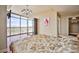 A bedroom with hardwood floors and a chandelier with a view of the city through large windows at 200 W Sahara Ave # 2407, Las Vegas, NV 89102