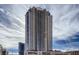 View of modern high-rise building exterior with glass balconies against a bright cloudy sky at 200 W Sahara Ave # 2407, Las Vegas, NV 89102
