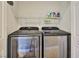 Convenient laundry area features new appliances and shelving for storage at 200 W Sahara Ave # 2407, Las Vegas, NV 89102
