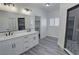 Modern bathroom featuring dual sinks, marble countertops, and a stylish glass shower at 2201 W Wisteria Way, Pahrump, NV 89048
