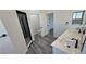 Bright bathroom features a double vanity, wood-look tile flooring, and a modern glass enclosed shower at 2201 W Wisteria Way, Pahrump, NV 89048