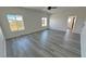 Bright bedroom features wood-look tile flooring, ceiling fan and multiple windows at 2201 W Wisteria Way, Pahrump, NV 89048