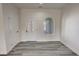 Inviting entryway featuring gray wood floors, a decorative front door, and arched window at 2201 W Wisteria Way, Pahrump, NV 89048