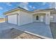 Attached three-car garage with concrete driveway and inviting, covered front porch at 2201 W Wisteria Way, Pahrump, NV 89048