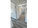 Clean and bright hallway features stylish gray wood flooring and white doors at 2201 W Wisteria Way, Pahrump, NV 89048