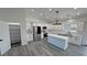 Modern kitchen with stainless steel appliances, white cabinets, and large island at 2201 W Wisteria Way, Pahrump, NV 89048