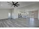 Open-concept living area showcasing modern kitchen, spacious layout, and stylish gray flooring at 2201 W Wisteria Way, Pahrump, NV 89048