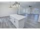 Open living space with kitchen island and view to the front entrance at 2201 W Wisteria Way, Pahrump, NV 89048