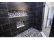 Modern shower featuring marble look tile, multiple tile storage nooks and hexagon tile floor at 2201 W Wisteria Way, Pahrump, NV 89048